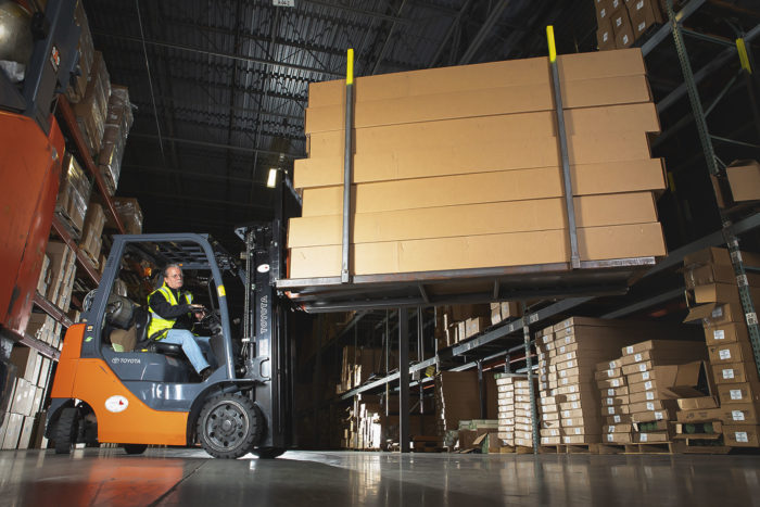 Service Partners Employee Moving Supplies with Forklift